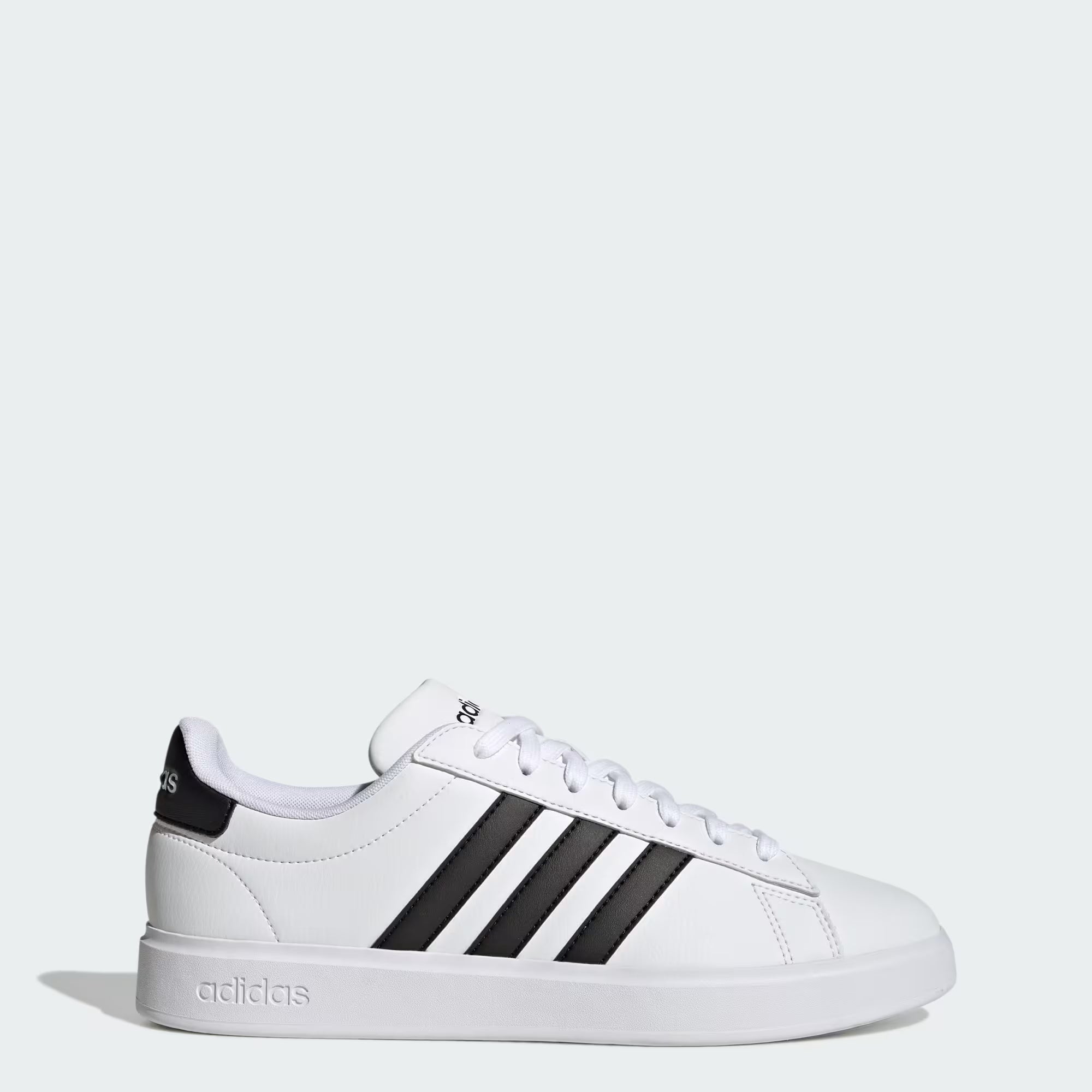The adidas Grand Court 2.0 - Men sneaker in Cloud White/Core Black/Cloud White, shown in side profile on a plain light background, features signature black stripes, white laces, and Cloudfoam Comfort for all-day cushioning.