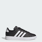 The adidas Grand Court 2.0 - Men in Core Black/Cloud White features classic white stripes, a white sole, and Cloudfoam Comfort cushioning. Side view on a light gray background shows the adidas logo on the heel and tongue.
