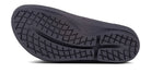 The image shows the black rubber sole of the OOFOS OOlala Luxe Sandal - Women, featuring a wavy tread and crosshatch grooves for grip. OOfoam technology boosts comfort, with embossed brand name and size details on the inner side.