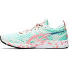 A mint green ASICS GEL-NOOSA TRI 12 Womens running shoe with a coral and white patterned sole, FLYTEFOAM midsole, pink accents, and mesh upper, shown in side view.