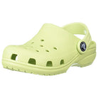 A Crocs Classic Clog - Kids in celery, featuring a ventilated upper, adjustable heel strap, and textured sole, is shown at an angle on a white background.