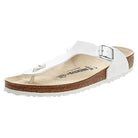A single white Birkenstock Gizeh Birko-Flor - Unisex sandal with a cork footbed, white buckle strap, and textured sole, shown at an angle.