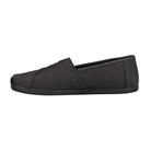 The TOMS Classic Canvas - Men in charcoal features a classic slip-on design and flat sole, displayed in side profile on a plain white background.