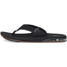 The Reef Fanning Low - Men in Black is a flip flop sandal with a cushioned sole, visible heel air bubble, simple thong strap, brown and black accents, and a built-in bottle opener on the outsole.