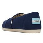 A single Alpargata ESP - Women slip-on in navy recycled cotton canvas, shown from the back with a white rubber sole and a blue and white TOMS heel label, reflecting the brand’s mission.