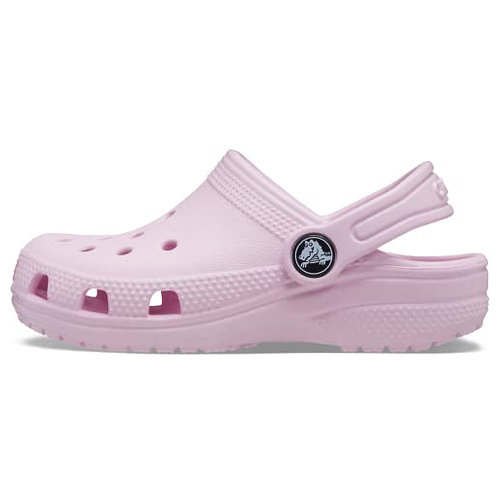 The Crocs Classic Clog - Kids in Ballerina Pink features ventilation holes, a textured sole, and an adjustable heel strap with the Crocs logo.