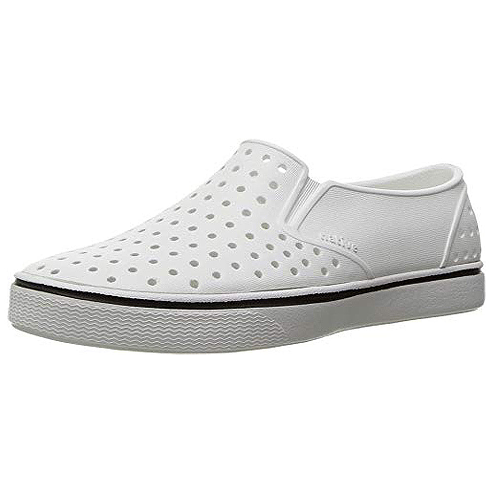 The Miles - Kids by Native Shoes Kids is a lightweight, low-profile slip-on loafer in Shell White with ventilation holes, elastic side panels, and a textured sole—perfect for active kids who love simple, minimalist style.