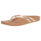 The Reef Cushion Spring Joy womens flip flop sandal in champagne features thin shimmery straps and a flat, slightly contoured cushion footbed, displayed on a white background.