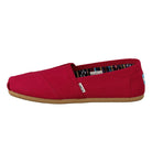 The TOMS Alpargata ESP - Women in Red Canvas features a classic slip-on design with a tan rubber sole and patterned lining, shown from the side—ideal for style lovers and fans of TOMS buy one give one spirit.
