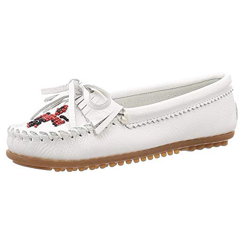 The Minnetonka Moccasins Thunderbird Beaded for women feature white smooth leather, intricate beadwork on the toe, decorative stitching, a chic bow, and a brown rubber sole with small grips for comfort.