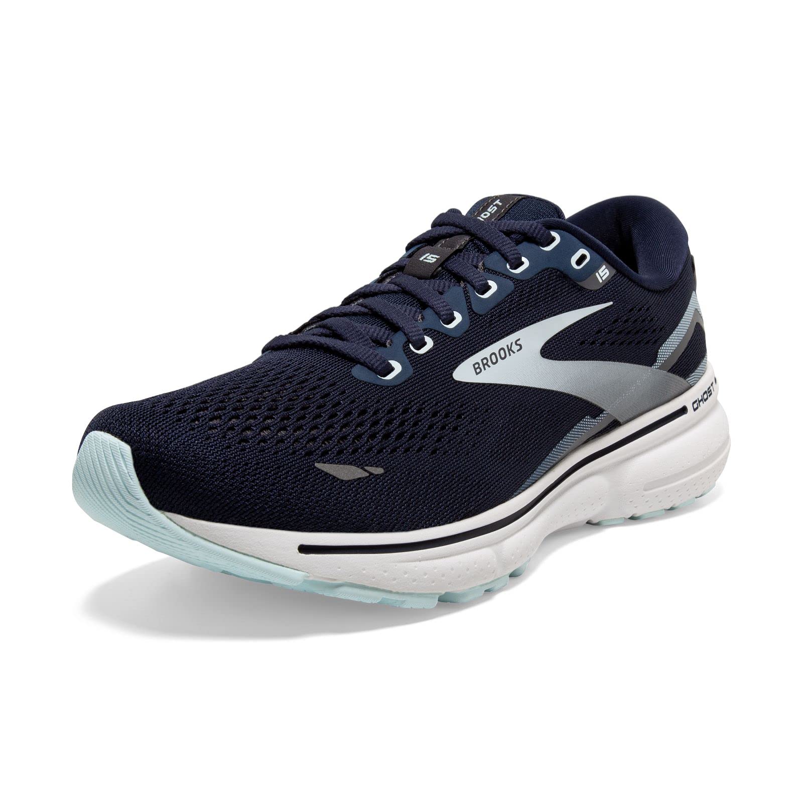 The Brooks Ghost 15 - Women shoe in Peacoat/Pearl/Salt Air features a waterproof Gore-Tex mesh upper, light blue sole, silver and gray accents, white midsole, laces, and Brooks branding on the side.