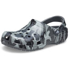 The Crocs Classic Camo Clog - Unisex features a Slate Grey Camo pattern, ventilation holes, and an adjustable heel strap for comfort. Displayed on a white background.