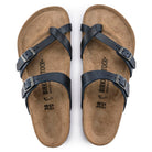 The Birkenstock Mayari Oiled Leather - Women sandals feature dark blue oiled leather crisscross straps with adjustable metal buckles and a contoured cork footbed, shown from above on a white background.