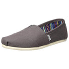 The TOMS Classic Canvas - Men in Dark Grey features a white sole, side tag, and colorful striped lining. Inspired by the classic TOMS design, this casual slip-on offers simple style with a comfortable canvas build.