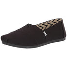 The TOMS Alpargata - Womens in Black/Black Canvas is a slip-on shoe featuring a small white tag, zigzag patterned lining, flat black sole, and eco-friendly recycled cotton.