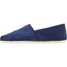 A side view of the TOMS Classic Canvas - Men alpargata in navy with a white sole, photographed on a plain white background.