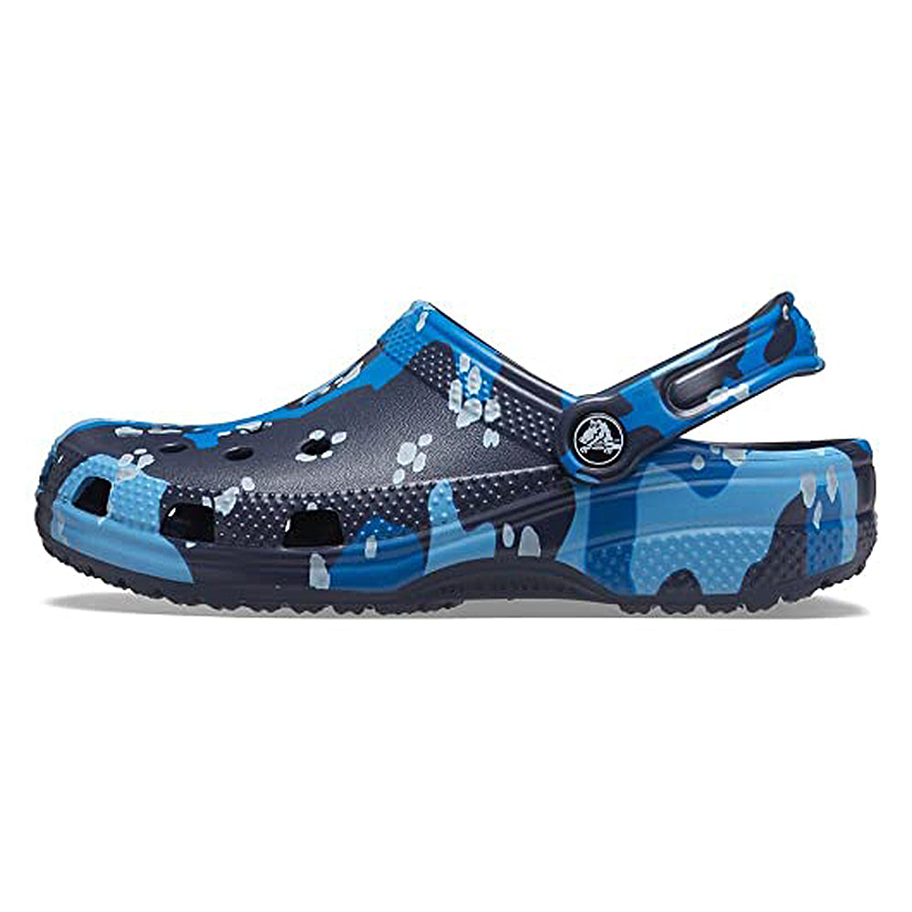 The Crocs Classic Camo Clog - Unisex in Navy Multi features a heel strap, ventilation holes, and a textured sole. Shown side-on against a white background, these stylish slip-ons are perfect as comfortable water shoes.