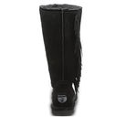 Back view of BEARPAW Tamara Boots for women, featuring tall black suede, side fringe details, a visible heel label, and a soft fuzzy lining inside.