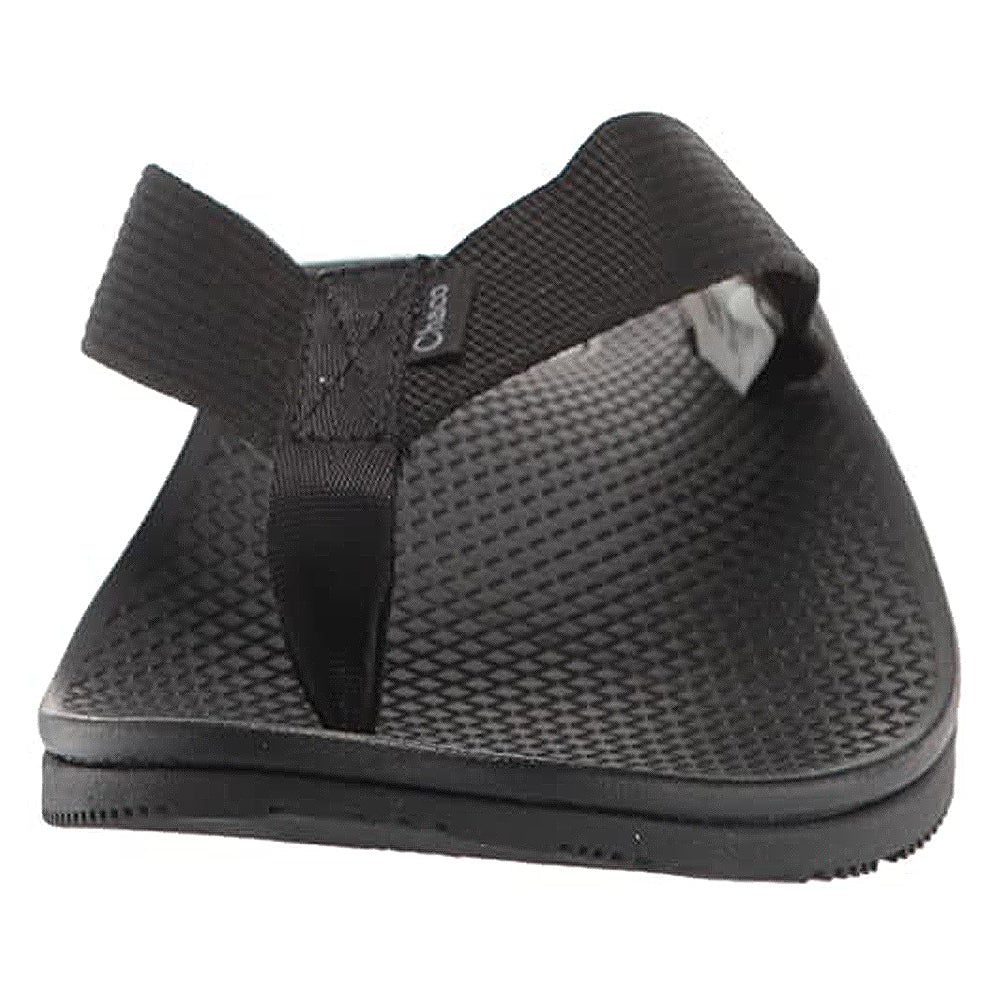 The Chaco Classic Flip - Men sandal in black is shown from the front, featuring wide straps, a textured footbed, flat sole, and durable ChacoGrip rubber outsole on a plain white background.