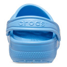 A close-up rear view of the Crocs Classic Clog - Kids in light blue, highlighting its textured sole and the Crocs logo embossed on the heel strap.