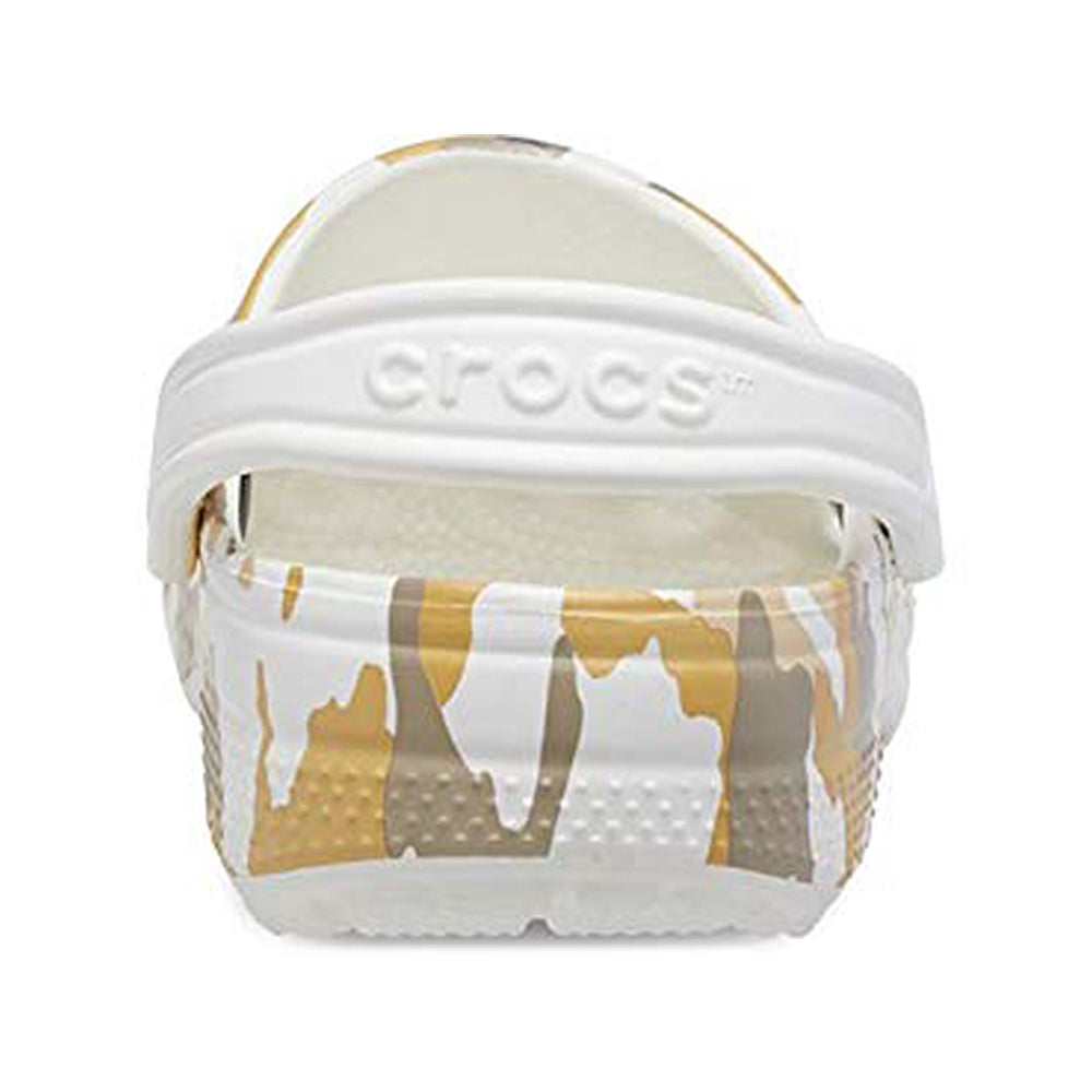 Rear view of the Crocs Classic Camo Clog - Unisex, showing a white heel strap and tan, brown, and white camo pattern. The Crocs brand name is embossed on the strap of these slip-on shoes.