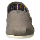 A front view of the TOMS Classic Canvas - Men slip-on shoe in gray, featuring visible stitching, a white sole, and a colorful striped inner lining.