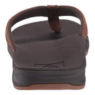 A close-up rear view of the Reef Ortho Coast Leather - Men flip-flop, featuring a brown thick sole with arch support, visible footbed, heel, and part of the strap.