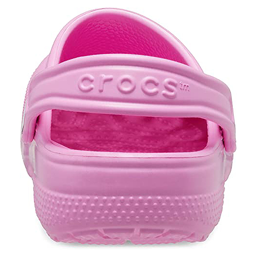 Rear view of a pink Crocs Classic Clog - Kids, featuring a heel strap with the Crocs logo and a textured sole—ideal for stylish children’s footwear.