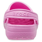 Rear view of a pink Crocs Classic Clog - Kids, featuring a heel strap with the Crocs logo and a textured sole—ideal for stylish children’s footwear.
