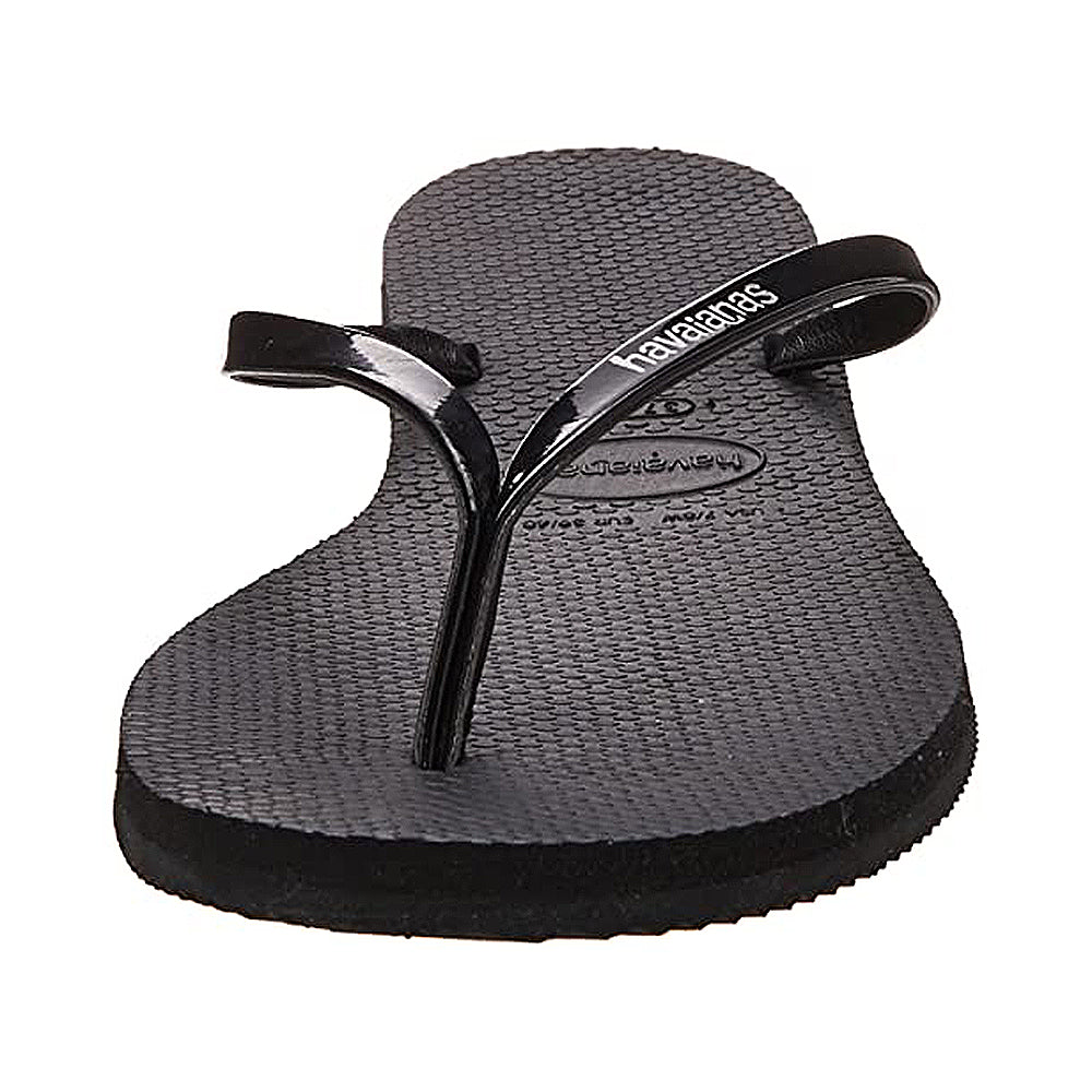 A single Havaianas Slim Metalic - Womens sandal in black, featuring a textured footbed and a thin metallic strap, displayed from the front on a white background.