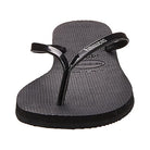 A single Havaianas Slim Metalic - Womens sandal in black, featuring a textured footbed and a thin metallic strap, displayed from the front on a white background.