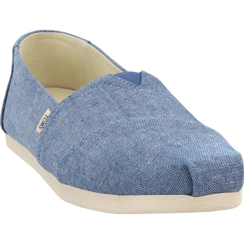 A single light blue TOMS Alpargata ESP slip-on shoe for women, featuring a textured fabric upper, white sole, side logo tag, and embodying the brands classic design and One for One giving commitment.
