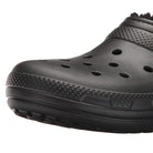 A close-up of the Crocs Classic Lined Clog - Unisex in black, featuring ventilation holes and a textured sole, photographed against a white background.
