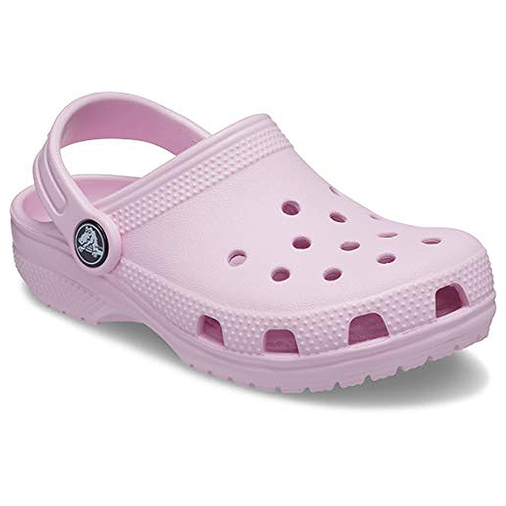 The Crocs Classic Clog - Kids in light pink features ventilation holes, a textured sole, and a pivoting heel strap, shown against a white background.