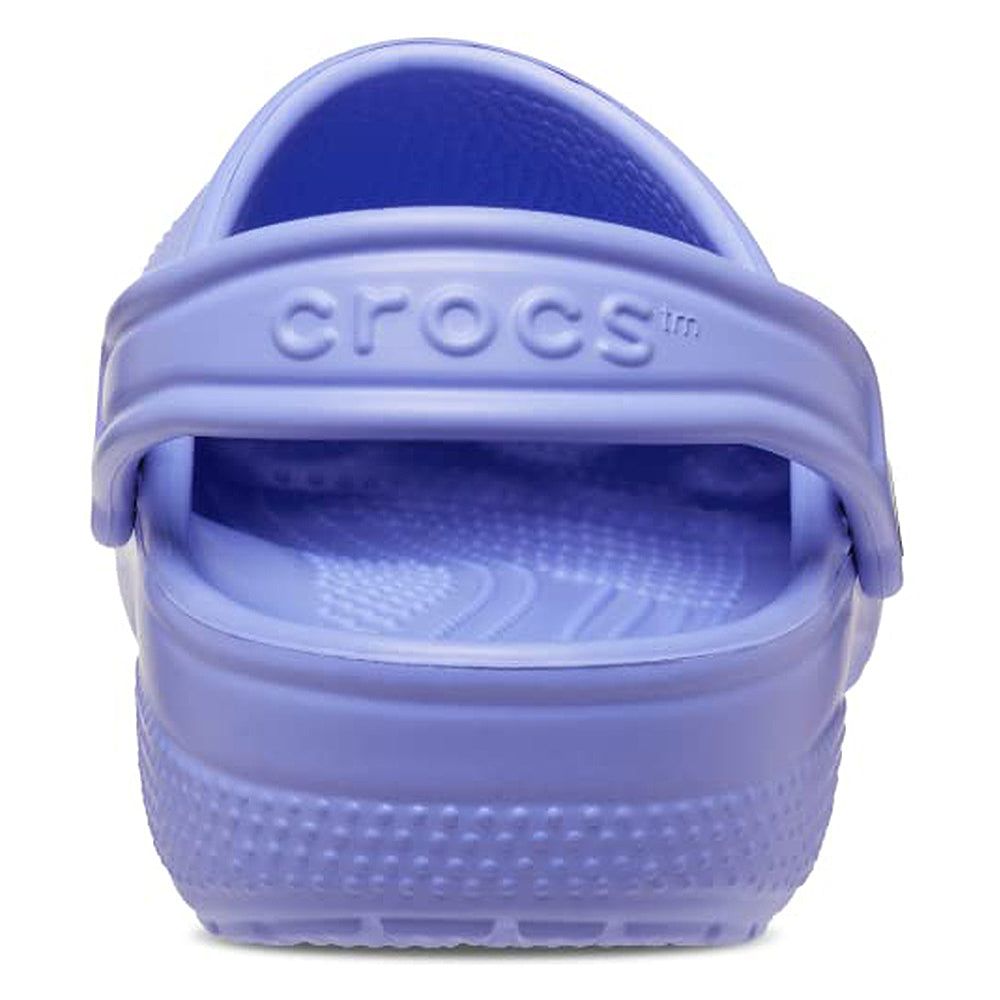 A close-up rear view of a single light purple Crocs Classic Clog - Kids shoe, highlighting the heel strap with the Crocs logo and the textured sole details.