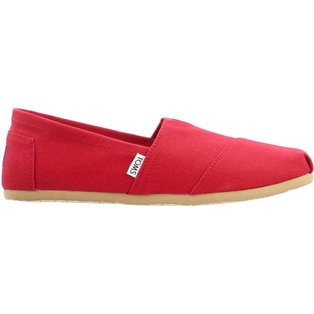 The TOMS Classic Canvas - Men is a red slip-on shoe with a beige rubber sole, white TOMS tag on the side, and blue heel patch.