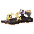 The Chaco ZX/2 Classic - Women in Revamp Gold features classic adjustable yellow, purple, and white straps with a black footbed and brown rubber sole, shown from a side angle.