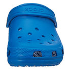 A front view of a single bright blue Crocs Classic Clog - Kids shoe, featuring top ventilation holes and a heel strap.
