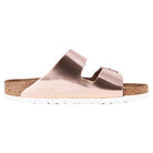 The Birkenstock Arizona – Womens sandal features rose gold, chunky double straps across the top, a cork footbed for orthopedic comfort, and a white sole, shown in a side view.
