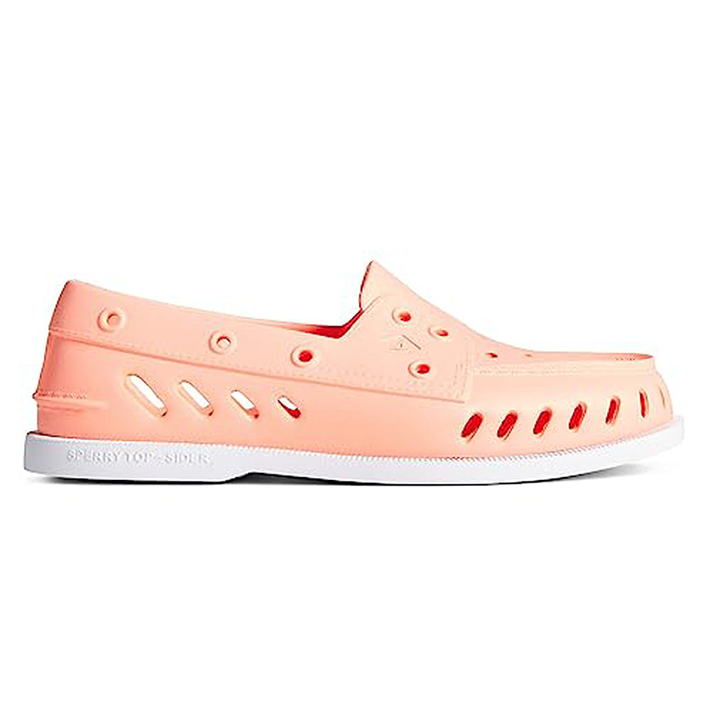 The Sperry Authentic Original Float Boat for women is a coral pink slip-on loafer with ventilation holes, drainage gills, and a white sole, offering casual style, comfort, and lightweight float.