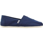 The TOMS Classic Canvas - Men shoe features a navy blue slip-on design with a white sole and a small TOMS tag on the side.