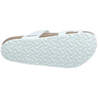 The Birkenstock Mayari Oiled Leather - Women sandal is pictured sole-up, showing its wavy tread. Its white oiled leather straps and cork contoured footbed are partially visible.