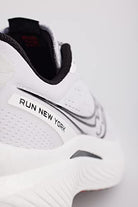 Close-up of the heel of a white Saucony Endorphin Speed 3 Running Shoe - Womens, featuring black accents and RUN NEW YORK text. The image highlights branding and textured details, emphasizing its appeal for daily training.