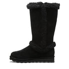 The BEARPAW Kendall Boots - Womens feature black suede, a flat sole, and black fur trim at the top, side, and ankle. Inspired by Lake Tahoe style, these cozy mid-calf boots have a rounded toe for all-day comfort.