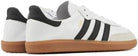 The adidas Samba Decon Shoes for men feature a white leather upper, black stripes, black heel tabs, and gum rubber soles—offering a timeless look.