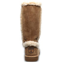 The BEARPAW Kendall Boots for women are tan suede winter boots with a shearling lining, fluffy cream trim, and a paw print logo on a small brown leather patch near the heel. Inspired by Lake Tahoe style and shown from the back.