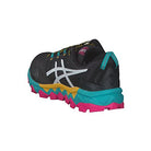 The ASICS GEL-FujiTrabuco 8 - Women’s trail running shoe features a black upper, white ASICS logo, teal and pink rugged sole, yellow accents, and teal heel detail, displayed from a rear-side angle on a white background.