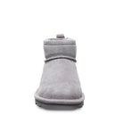 Front view of a single BEARPAW Shorty Boots - Womens in light gray suede, featuring a rounded toe, flat rubber sole, and modern minimalist design.