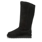 The BEARPAW Tamara Boots for women, shown in profile against a white background, feature classic black suede with a flat sole and mid-calf height, reflecting the brands signature style and renowned craftsmanship.