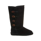 The BEARPAW Lori Boots for women are black, mid-calf suede boots with four brown toggle buttons on the outer side and a cozy sheepskin wool lining for added warmth.